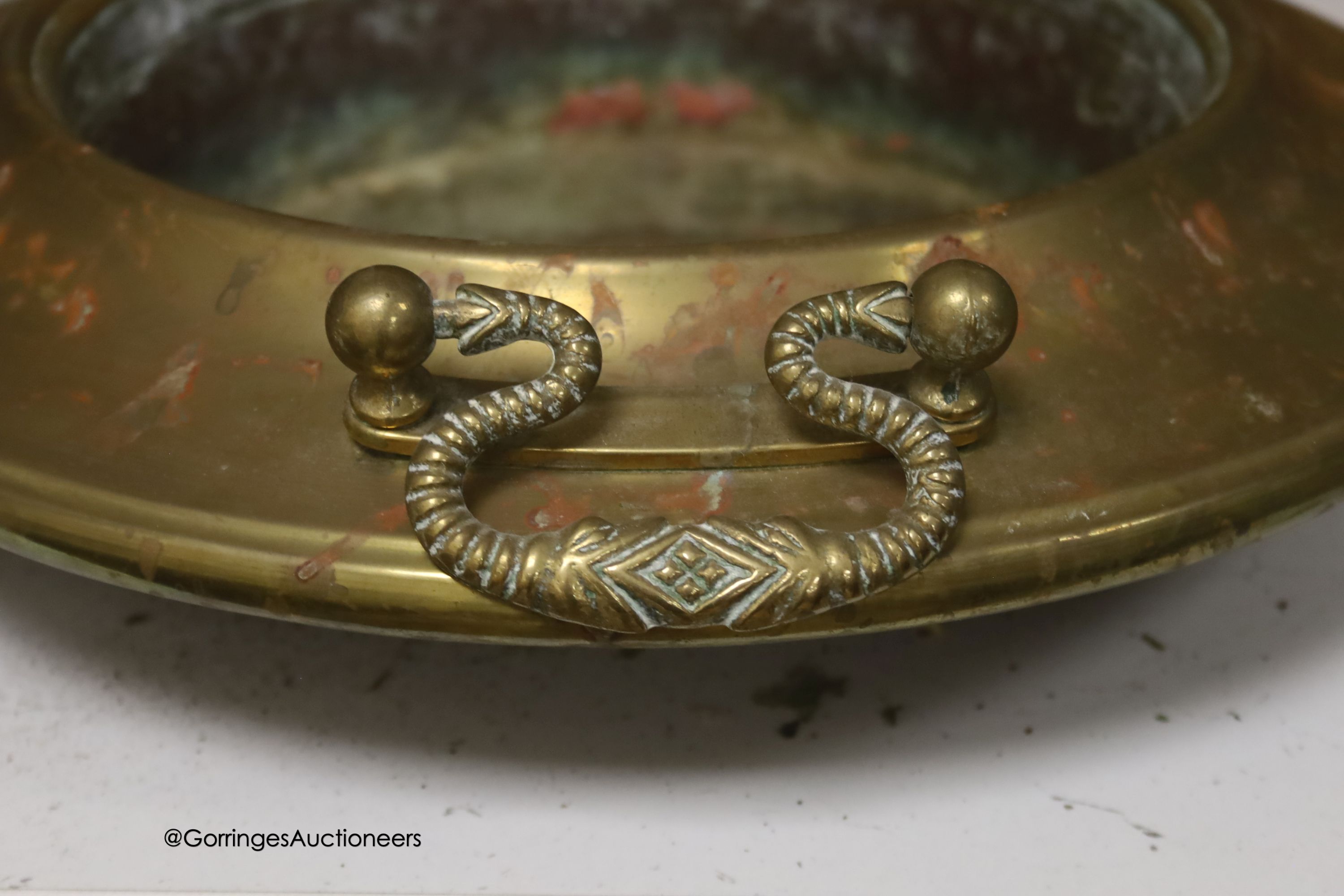 A circular brass two handled bowl, diameter 38cm